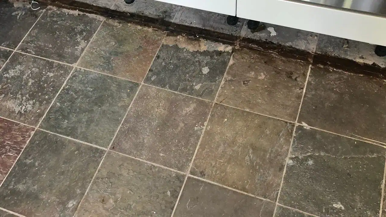 Worn slate floor showing the stages that separate cleaning, repair, sealing, and restoration